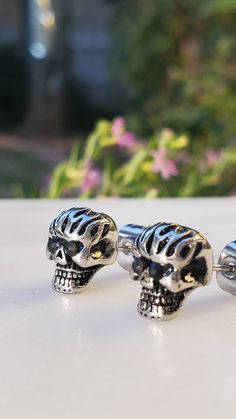 Description: Embrace a rebellious and edgy style with these Stainless Steel Black Cz Girls Biker Skull Stud Earrings. Crafted for those who love to make a statement, these earrings bring together toughness and glamour in a unique design. Product Features: Stainless Steel Construction: The earrings are made from durable stainless steel, ensuring longevity and resistance to tarnish. Black Cubic Zirconia Accents: The black cubic zirconia stones add a touch of darkness and sparkle, creating a bold and distinctive look. Biker Skull Design: The skull motif gives these earrings a rebellious and biker-inspired aesthetic, perfect for those with a daring sense of style. Stud Style: The stud design makes these earrings easy to wear daily, adding a hint of attitude to your look. Versatile Accessory: W Black Skull-shaped Earrings With Skull Print, Edgy Nickel-free Skull Earrings, Edgy Pierced Skull Jewelry, Biker Style Skull Jewelry, Edgy Skull-shaped Pierced Earrings, Black Gothic Earrings With Skull Print, Skull Print Gothic Jewelry For Streetwear, Punk Skull Jewelry For Biker Events, Black Skull Print Jewelry For Streetwear