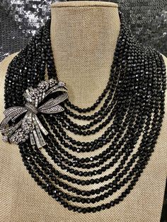 "Heidi Daus Best In Bows Crystal Accented 13 Strand Black Bib Necklace Swarovski Crystals BIG, BOLD & BEAUTIFUL Statement piece fit for a queen! Absolutely Magnificent. This necklace features 13 strands of black faceted beads. An asymmetrically placed bow in clear round and black diamond Swarovski crystals lies on the side of this necklace. Certainly not for the timid, but a showstopper for sure. It will have people swarming around you to get a glimpse of this piece of art. Approx 19\" with New Hair Look, Black Diamond Necklace, Necklace Swarovski, Heidi Daus, Double Strand Necklace, Enamel Beads, Bib Necklace, Strand Necklace, Jewellery Making