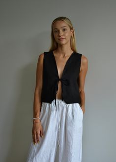 Our relaxed-fit linen vest with a front tie is the perfect piece for summer days. Made from 100% OEKO-TEX certified linen, it's both comfortable and breathable. This versatile vest looks great with jeans, shorts, or pants--really, it complements any outfit. If you're after a romantic yet stylish look this summer, this vest is just what you need. DETAILS: - Front Tie (We can add second tie for better support upon request) - V neck  - Relaxed Fit  - Customization available: We can shorten the fron Linen Vacation Tops With Tie Straps, Sleeveless Linen Summer Vest, Linen Tops With Tie Straps For Vacation, Spring Linen Beach Vest, Sleeveless Top With Drawstring Tie For Vacation, Casual Linen Tie-back Tops, Casual Sleeveless Tops With Tie Waist, Beach Linen Tops With Tie Waist, Summer Beach Linen Vest