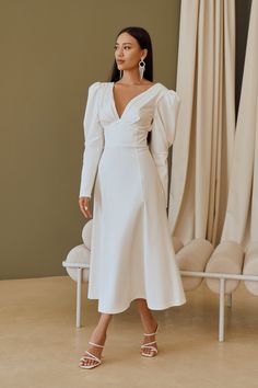 Fabric: Heavy Satin Cotton 50%, Polyester 50% V-neck dress Puffed sleeves Long sleeves Bow on back detail Zipper on back Dress lenght: 125 cm/ 49,2 inSleeve length: 68 cm/ 26,7 in Colors: White, Sky-Blue, Dusty Pink White Sky, Back Details, Bow Back, Puff Sleeve Dresses, Satin Bow, Puffed Sleeves, White Midi Dress, Back Dress, White Satin