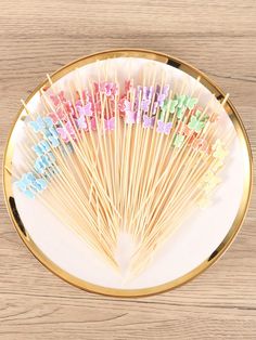 colorful lollipop sticks are on a plate