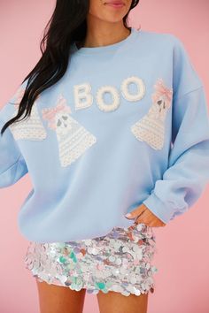 Bewitch in style with our GHOULS RULE BLUE PULLOVER! This light blue pullover features spellbinding white beaded "Boo" letters, accented with charming lace ghost patches and playful pink bows. A must-have for any spirited fashionista. Tricks and treats not included. All orders are currently shipping within 14 business days. To receive item quicker, expedited shipping is available at checkout. **ALL HALLOWEEN ORDERS MUST BE PLACED WITH EXPEDITED SHIPPING TO GUARANTEE DELIVERY BY OCT. 31 IF PLACED Lace Ghost, Halloween Clothes, Holiday Halloween, Pink Bows, Blue Pullover, Oct 31, White Beads, Pink Bow, Halloween Outfits