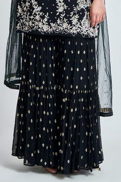 Black viscose georgette padded kurta with hand crafted sequence work with zarkan. Paired with an embroidered sharara with scattering sequence work and dupatta.
Components: 3
Pattern: Embroidered
Type Of Work: Sequin
Neckline: Round
Sleeve Type: Three-quarter
Fabric: Viscose Georgette
Color: Black
Other Details: 
Attached lining
Length:
Kurta: 36 inches
Sharara: 44 inches
Approx. product weight: 1.5 kgs
Closure:
Sharara: Zipper
Model Height: 5 ft 9 inches, wearing size M
Occasion: Sangeet - Aza F Embroidered Sharara, Kurta Sharara Set, Kurta Sharara, Sequence Work, Sharara Set, Set For Women, Aza Fashion, Model Height, Sleeve Type