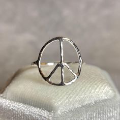 This is a handmade peace symbol ring,  Express your inner hippie with this handcrafted peace symbol ring!  Also available in 14k gold filled. Carefully and lovingly made in 925 sterling silver, hammered and textured for extra shine.  Made to order!  Size and dimensions: Available in any size 1-16 US including halves.  Peace symbol is about 17mm  Band thickness is 16guage or 1.2mm Shipping label upgrade:  First class shipping 2-6 days Priority Mail shipping 1-4 days  https://www.etsy.com/listing/1241333454/ Hippie Sterling Silver Nickel-free Jewelry, Adjustable Spiritual Jewelry With Peace Sign, Rings Hippie, Peace Sign Ring, Silversmith Rings, Adjustable Sterling Silver Peace Sign Jewelry, Vintage Peace Sign Jewelry Gift, Hippie Rings, Shipping Label