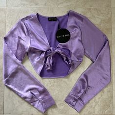 White Fox Boutique Girls Vacay Long Sleeve Tie Front Satin Purple Crop Top Size Xs Nwt Fitted Purple V-neck Crop Top, Fitted V-neck Purple Crop Top, Chic Purple Long Sleeve Crop Top, Chic Long Sleeve Purple Crop Top, Purple Long Sleeve Crop Top For Spring, Chic Purple Crop Top For Day Out, Purple Crop Top, White Fox Boutique, Girls Boutique