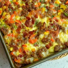 a casserole dish with meat, cheese and vegetables