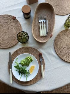 the table is set with place settings and utensils for two people to eat