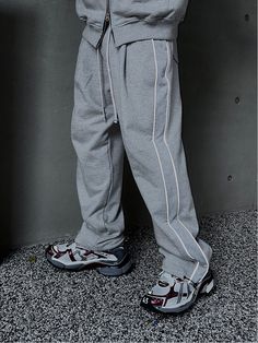 Editor's NotesThis voluminous sweatpants is designed with reflective 3M piping along the side panels and adjustable drawcord and stopper at the hem that allow creating versatile silhouette. It's topped with comfortable banding waist to fits easily for unisex. - Elasticated drawstring waistband- Two front on-seam pockets- Two back patch pockets- Front tucks- Side panel with 3M reflective piping- Adjustable drawcord at the hem- Wide balloon fit- Unisex wearMeasurements (in.) One size- Waist: 14.2 in. - Thigh: 14.2 in. - Rise: 14.2 in.- Hem: 9.4 in.  - Total Length: 42.5 in.Model Info: 5' 10.9/ Fitting size Top one size, Bottom one sizeComposition & Care- Cotton- Refer to the care labelDesigner- by CLACO Spring Joggers With Side Stripes For Jogging, Sporty Sweatpants With Side Stripes For Spring, Athleisure Wide Leg Sweatpants With Side Stripes, Sportswear Pants With Drawstring For Jogging, Sportswear Jogging Pants With Drawstring, Spring Sweatpants With Side Stripes For Jogging, Relaxed Fit Athleisure Tracksuit With Drawstring, Athleisure Tracksuit With Drawstring And Relaxed Fit, Spring Sportswear Sweatpants With Side Stripes