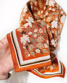 Add extra elegance to any outfit with a lush, 100% silk bandana. These have a luxurious crepe texture, which makes them a matte silk, and keeps them from slipping as much as silk with more sleek of a sheen. These silks are created from hand illustrated Flora West designs. This Botanical Garden colorway is a colorful floral pattern that pops on its bright carrot orange background. The design is digitally printed onto the silk material, and finished off with an invisible hand rolled edge seam. Sil Head Scarf Illustration, Silk Scarf Pattern Design, Luxury Scarf Design, Silk Scarf Pattern, Botanical Scarf, Printed Hijab, Illustration Tips, Hijab Design, Scarf Designs