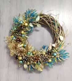 a christmas wreath with pine cones and ornaments