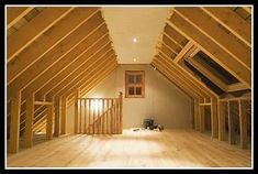 an attic with wooden flooring and exposed rafters on the ceiling is shown in this image