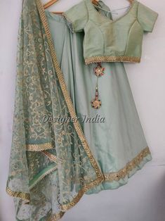 Looking for something special and unique to wear at your wedding? Look no further than our mint green lehenga choli dupatta! This beautiful piece of party wear is designed by one of India's leading fashion designers, and is perfect for bridesmaids, female guests, or even yourself as the bride. Made from tafetta silk fabric with a delicate mint green color, this lehenga choli dupatta will add an elegant touch to any outfit you choose to wear it with. Don't miss out on this must-have item for your Pista Green Cutdana Lehenga For Navratri, Pista Green Lehenga With Gota Work In Traditional Drape, Unstitched Pista Green Lehenga With Gota Work, Traditional Drape Pista Green Lehenga With Gota Work, Semi-stitched Pista Green Choli With Gota Work, Designer Pista Green Lehenga With Gota Work, Pista Green Lehenga With Gota Work, Fitted Pista Green Lehenga With Gota Work, Pista Green Choli With Gota Work For Diwali