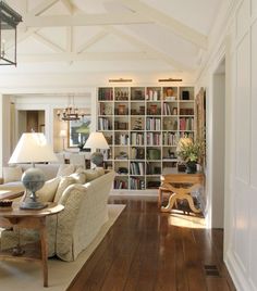 a living room filled with furniture and bookshelves