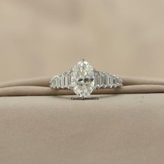 an oval diamond ring with baguetts on top