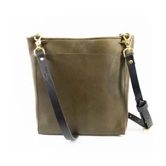 Olive Green Needless to say, this bag has earned its name. The classic crossbody bag, perfect for carrying every day. Available in lots of fun colors, to keep those days interesting. Pairs perfectly with our additional bag straps, because classic should never mean boring.Features: Full grain leather bag with crossbody strap Large front pocket Compartmentalized inside pocket Magnetic closure Solid brass hardware Dimensions: 13in wide, 10.5in tall, 3in deep 8 x 6 interior compartmentalized pocket Full Grain Leather Bag, Classic Crossbody Bag, Those Days, Brass Hardware, Bag Straps, Crossbody Strap, Magnetic Closure, Full Grain Leather, You Bag