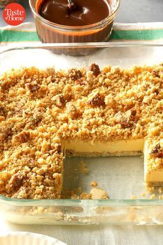 a cake that has been cut into pieces and is sitting on a table with other desserts in the background