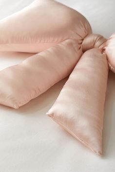 three pillows are folded on top of each other in the shape of an origami