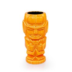 an orange ceramic tiki vase on a white background