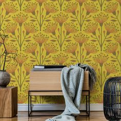 a yellow wallpaper with orange flowers on it and a black birdcage next to it