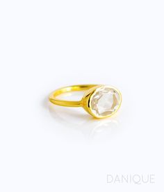 "You'll fall in love with the stunning clarity and reflective quality of this crystal Clear Quartz ring. This is a perfectly sized oval to compliment any collection. Popular as a birthday gift for those April babes and Quartz lovers alike. This is a completely transparent stone with no flaws. Clear Quartz is a common alternative to diamond. This stone is beautifully faceted and bezel set in a 925 sterling silver band or plated with 18k vermeil gold. Gemstone is approximately 8 x 12mm. Band has 9 Oval Moonstone Ring With Diamonds In Yellow Gold, Oval Diamond Moonstone Ring In Yellow Gold, Luxury Oval Moonstone Anniversary Ring, Modern Oval White Topaz Ring, Modern Oval Crystal Ring With Gemstone, Modern Crystal Ring With Oval Gemstone, Timeless Oval Moonstone Ring For Formal Occasions, Modern Oval Birthstone Ring With Gemstone, Oval White Topaz Crystal Ring