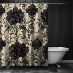 a bath tub sitting next to a black and white shower curtain with flowers on it