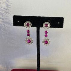 4ct Total Weight Red Ruby & White Cz's 925 Solid Sterling Silver Post Earrings Faceted Round Ruby And Sprinkling White Cz's 925 Silver Earrings Settings 1.25 Inch Drop Top Ruby Is 4mm And Bottom Ruby Is 5 Mm July Birth Stone Is Ruby And This Is One Great Birthday Gift Earth Mined Rubies That Are Heat Enhanced To Bring Out The Deep Red Color Post, Stud, Earth Mined, Red Rubies Ruby Earrings With Brilliant Cut In Fine Jewelry Style, Ruby Brilliant Cut Fine Jewelry Earrings, Fine Jewelry Ruby Earrings With Brilliant Cut, Ruby Earrings Brilliant Cut Fine Jewelry, Formal Red Diamond Earrings With Brilliant Cut, Classic Ruby Diamond Earrings With Accents, Classic Ruby Diamond Earrings With Diamond Accents, Red Brilliant Cut Fine Jewelry Earrings, Aaa Quality Red Jewelry For Formal Occasions