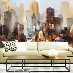 a living room with a couch, coffee table and large cityscape on the wall