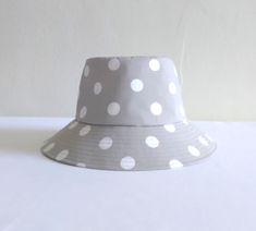 "This trendy bucket hat is practical. Perfect for enjoying sunny day, beach escape, pool side or wearing in the city. Easy packable. Sewn from light grey with white polka dots cotton fabric. Size: Crown: 22 1/2\" - 57cm Brim: 2 3/4 \" - 7 cm Size can be customized" Garden Hat, Gardening Hat, Pool Side, Hat Summer, Summer Hat, Beach Hat, Summer Hats, Sun Hat, White Polka Dot