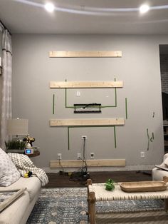 a living room with two couches and a tv mounted to the wall above them