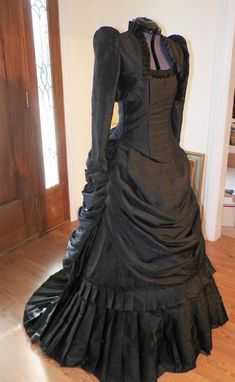 Elegant Black Ball Gown For Costume Party, Fitted Black Ball Gown, Black Fitted Satin Ball Gown, Fitted Black Satin Ball Gown, Fitted Taffeta Dress With Satin Finish, Fitted Black Ball Gown For Costume Party, Black Gothic Satin Dress, Fitted Purple Gown With Pleated Bodice, Black Fitted Satin Finish Dress