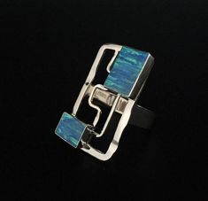 Hi everyone, just wanted to let you know we are open and shipping daily.Stunning one of a kind opal and sterling silver ring. This Japanese opal has a vibrant sheen diffracting a wide spectrum of color. Although lab made, this opal contains silica as well as a similar chemical composition to natural opal taking more than 3 years to produce and is vastly superior to synthetic opal. It is set in 925 sterling silver and finished on the back side. This line of opal has been a top seller at my store Modern Opal Ring For Anniversary, Modern Silver Opal Gemstone Ring, Modern Silver Opal Ring With Gemstone, Unique Sterling Silver Opal Inlay Ring, Unique Sterling Silver Opal Ring With Inlay, Modern Sterling Silver Opal Ring Gift, Modern Sterling Silver Opal Ring For Gift, Blue Fire Opal, White Pearl Earring