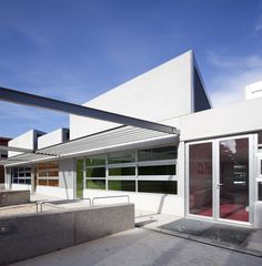 a white building with lots of windows and doors