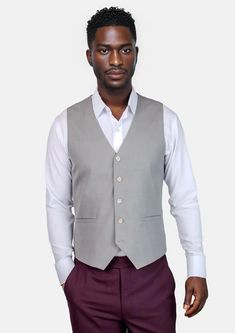 Featuring a classic grey with a hint of color in a sharkskin weave, this luxury, custom-made vest is a stylish bespoke piece perfect for making a sophisticated impression. Classic Gray Vest For Work, Classic Gray Formal Vest, Gray Fitted Vest For Business, Fitted Gray Vest For Business, Elegant Sleeveless Gray Vest, Classic Tailored Gray Vest, Gray Tailored Vest For Business, Fitted Gray Vest For Workwear, Gray Sleeveless Vest For Formal Occasions