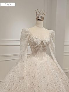 a white wedding dress with a crown on top