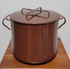 a brown pot sitting on top of a wooden table