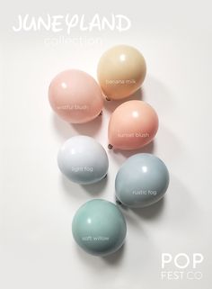 four different colored eggs sitting on top of each other in front of a white background