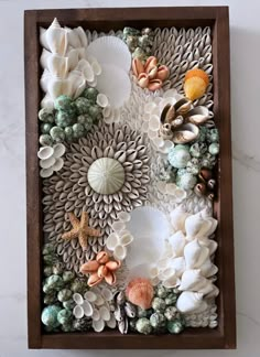 a wooden box filled with shells and seashells