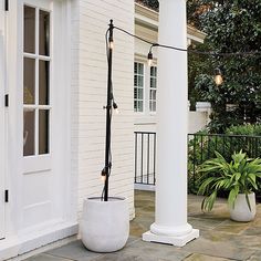 an outdoor area with two large white planters