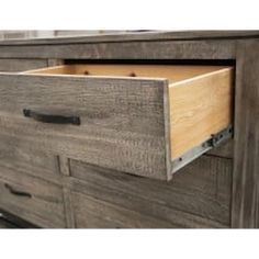 a large wooden dresser with two drawers and an open drawer on the bottom one side