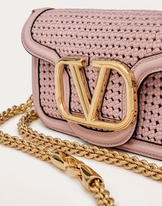 Valentino Garavani Locò small shoulder bag in woven leather with metallic VLogo Signature detail. Equipped with both a detachable sliding chain strap and a detachable handle, this accessory can be worn as a crossbody/shoulder bag or carried as a handbag. - Gold-finish hardware - Magnetic closure - Detachable leather handle - Shoulder strap with detachable sliding chain - Interior: one leather slip pocket - One leather slip pocket on the back - Shoulder strap drop length: min. 33 cm to max Valentino Mini Bag, Valentino Black Mini Bag, Valentino Small Bag, Valentino Salvy Bag, Valentino Sequin Bag, Bow Mules, Escape Bag, Studded Sneakers, Wedge Loafers