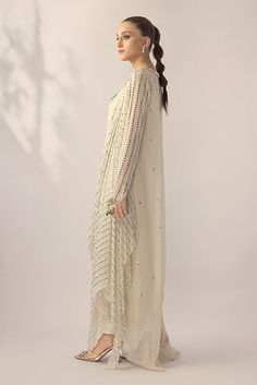 An ivory georgette long shirt with a draped dupatta is handworked with delicate kamdani. The sleeves and neckline are detailed with jewelled floral motifs. An elegant ensemble for any formal event or soiree. Elegant Resham Embroidered Georgette Pre-draped Saree, Elegant Anarkali Set With Cape Sleeves And Dupatta, Elegant Off White Pre-draped Saree For Festive, Elegant Pre-draped Saree With Sheer Dupatta In Georgette, Elegant Pre-draped Georgette Saree With Sheer Dupatta, Hand Embellished Semi-stitched Georgette Pre-draped Saree, Designer Georgette Cream Pre-draped Saree, Hand Embellished Semi-stitched Pre-draped Saree In Georgette, Wedding Georgette Kurta Hand Embellished