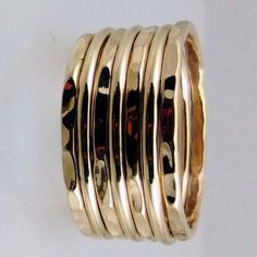 This Hammered & Polished Gold-filled stacking ring set is entirely hand-made & mixes well with most of the items in our store. * This listing is for one 7-band set. You will receive: * Four 16g Hammered Gold-filled rings * Three 16g Polished Gold-filled rings * When stacked, they measure at about 7 rings per half inch. * We do make 1/2 & 1/4 sizes, just leave a note with your size preference. * All of our items are entirely hand crafted and have a standard processing time of 3-5 Business days to Stackable Adjustable Rings With Thick Band, Adjustable Thick Band Stackable Rings, Modern Wide Stackable Bands, Stacked Round Rings As Gift, Gold Stackable Thick Band, Classic Handmade Gold Stackable Rings, Handmade Jewelry With Thick Band For Everyday, Handmade Adjustable Wide Band Stackable Rings, Handmade Thick Band Jewelry For Everyday