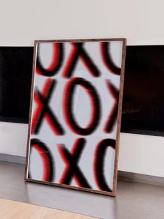 an abstract painting on the wall in front of a fireplace with a black and white background