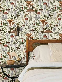 a bed sitting next to a wall covered in lots of different types of wallpaper