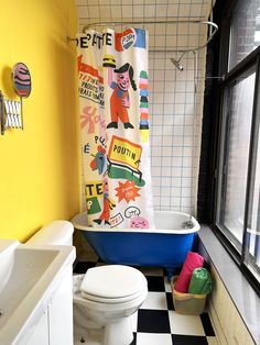 a bathroom with yellow walls, black and white checkered flooring and a blue tub