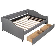 a bed with two drawers underneath it and a mattress on the bottom one is made up