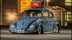 an old vw bug with luggage on top