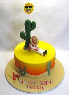 a birthday cake with an image of a cactus and a person holding a rocket on top