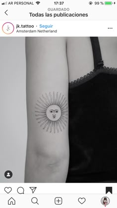 a woman's arm with a small sun tattoo on the left side of her arm