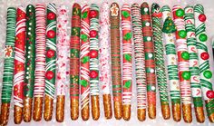 christmas candy canes are lined up on a table with white and green wrapping paper